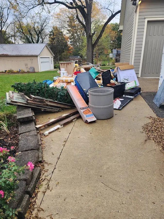 Dumpster being loaded with debris for 12 Yard Dumpster Rental in Maeser